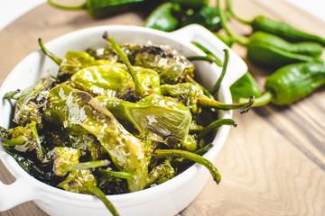 Roasted Padron Green Peppers in White Bowl. Pimientos de Padron. - 268627106