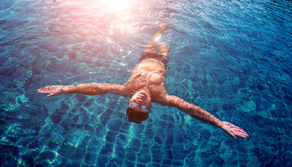 Young athletic man swimming in the swimming pool © romaset