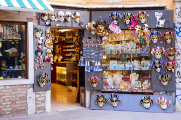 VENICE, ITALY - MAY, 2017: shop full of traditional masks and souvenirs in a small stree. During...