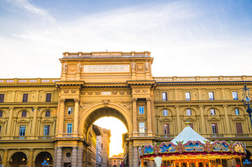 Fototapeta na wymiar Arch between buildings and Vintage carousel on Piazza della Repubblica Republic square in historical centre of Florence city, blue sky white clouds, Tuscany, Italy