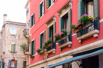 Naklejka premium VENICE, ITALY - MAY, 2017: Flower boxes below a window in Venice, Italy