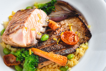 Roasted Salmon Fillet with Vegetables on Rustic White Plate. Healthy Food Concept.