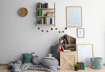 Cozy place for reading books near wall in room