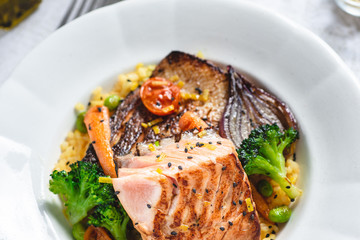 Roasted Salmon Fillet with Vegetables on Rustic White Plate. Healthy Food Concept.