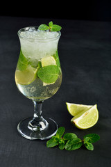 Mojito cocktail drink with lime Ice and mint on dark background with Copy space