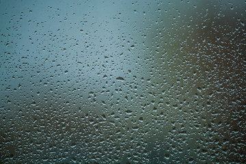 Background or texture. It is a lot of small a rain drops on window glass. Rainy day of spring.