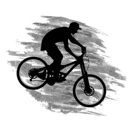 Fototapeta na wymiar Silhouette of a cyclist going down on a mountain bike on a slope