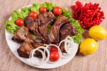 barbecue on a plate with herbs and vegetables. Russian restaurant. The concept of the menu.