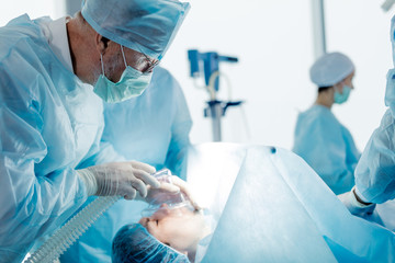 emergency resuscitation for dying man.doctor controlling the breath of client in the clinic.