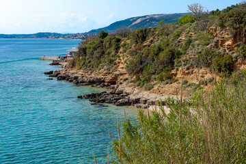 Obraz premium View from a beach during summer, located on a beautiful island of Rab on the Adriatic coast in the heart of Mediterranean sea. Surrounded by the crystal clear turquoise sea and blue sky.