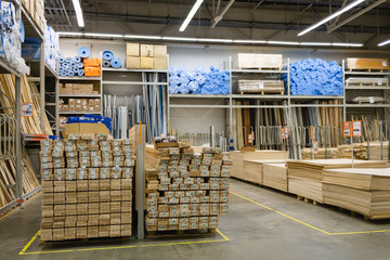 ST. PETERSBURG, RUSSIA - MARCH, 2019: Wood stacked on shelving inside a lumber yard