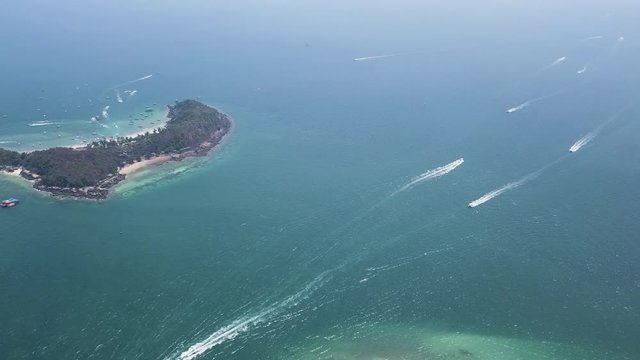 High Altitude Aerial Drone View Of Multiple Speed Boats Departing And Arriving From Tropical Island Resorts - Tourist Boats Passing A Exotic Beach Island Surrounded By Green Lush Sea Thailand, Asia 4k