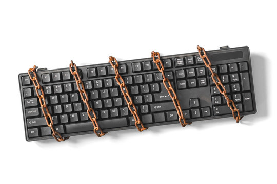 Black Keyboard With A Coiled Chain. Concept For The Topic Of Censorship Or Freedom Of The Press.