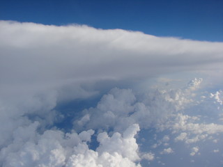 Panorama of a soft, snow-white cloud blanket in heavenly blue from a height of 9,000 m above the Mediterranean Sea.