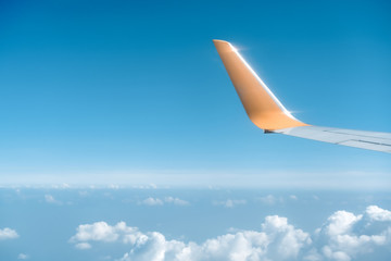 Top view on plane of Blue sky and plane wing.