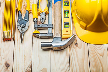 yellow helmet and construction tools on wooden boards