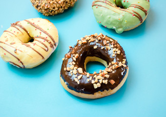 Donuts assorted with glazed on blue and pink background