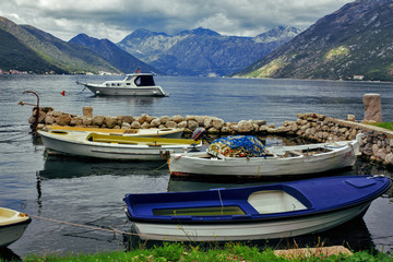 three fishing boats moored in small dock in bay, Montenegro