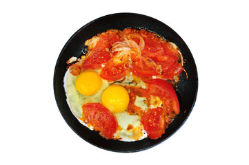 Vegetarian dinner of two eggs and tomatoes, fried on fire in a frying pan