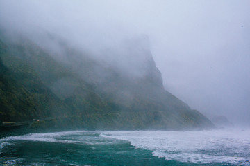 Waves of a raging dark sea crashing on rocks