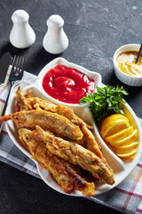 Fried small capelins with tomato sauce, top view