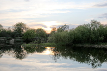 Fototapeta na wymiar In the evening on the river. Sunset