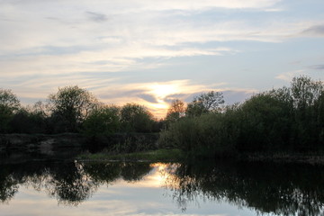 Orange sunset over the river in spring