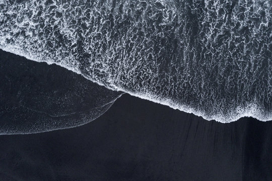 Fototapeta Aerial drone shoot from above black sand beach. Nature texture