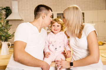 beautiful family dad mom and daughter have fun in a apartment