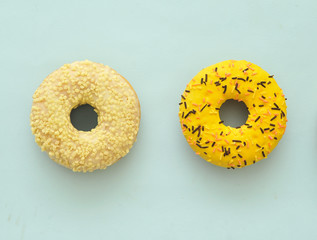 Delicious donuts on light pastel color background. National Donut Day concept.