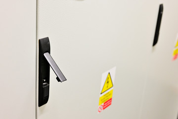Black lever for cabinet door opening.