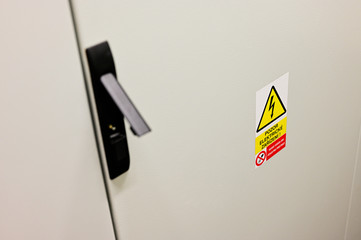 Warning sign stuck to cabinet door.