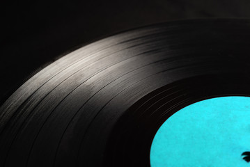 Segment of vinyl record with label showing the texture of the grooves