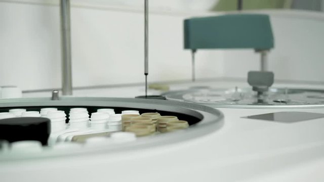 Biochemical laboratory blood test by medical diagnostic equipment rotating centrifuge robot. Biochemistry lab research, centrifugal spectrograph analyzer instrument spin and testing material in tubes