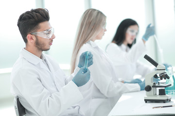 group of young biologists sitting at the laboratory table