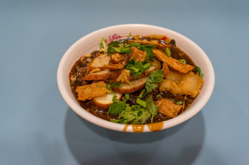 White plate with spicy asian style soup