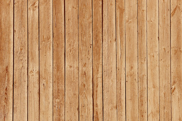 The texture of brown from old wooden planks arranged in a vertical order. Background for further design. Ancient building material. Rough relief texture of natural wood. Combustible insulating surface