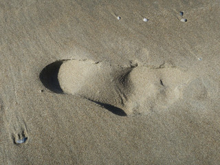 heel spur, print of a foot in the snad of the beach