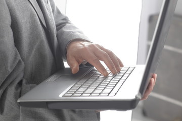 close up.businessman typing on a laptop keyboard.isolated on white background