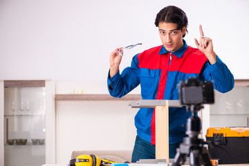 Young contractor recording video for his blog 