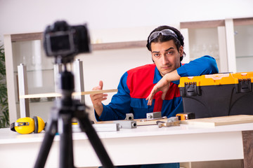 Young contractor recording video for his blog 