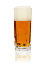 Glass with cold beer, foam. Isolated on a white background with reflection