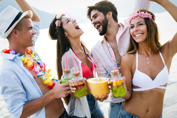 Group of happy friends partying and having fun on summer vacation