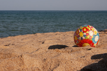 Children's multi-colored ball on the beach