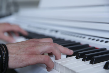 Fototapeta premium hands playing the white piano