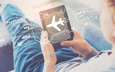 Airplane travel theme with man using a tablet in a chair