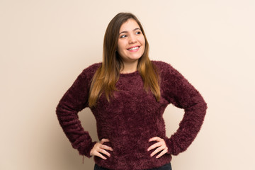 Young girl posing with arms at hip and smiling