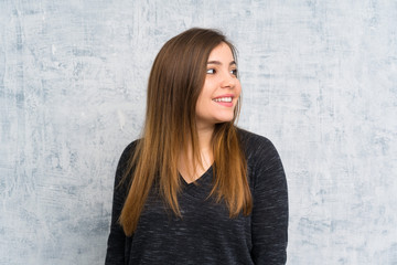 Young girl over grunge wall laughing