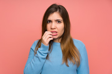 Fototapeta premium Young girl with blue sweater nervous and scared