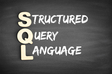 Wooden alphabets building the word SQL - Structured Query Language acronym on blackboard